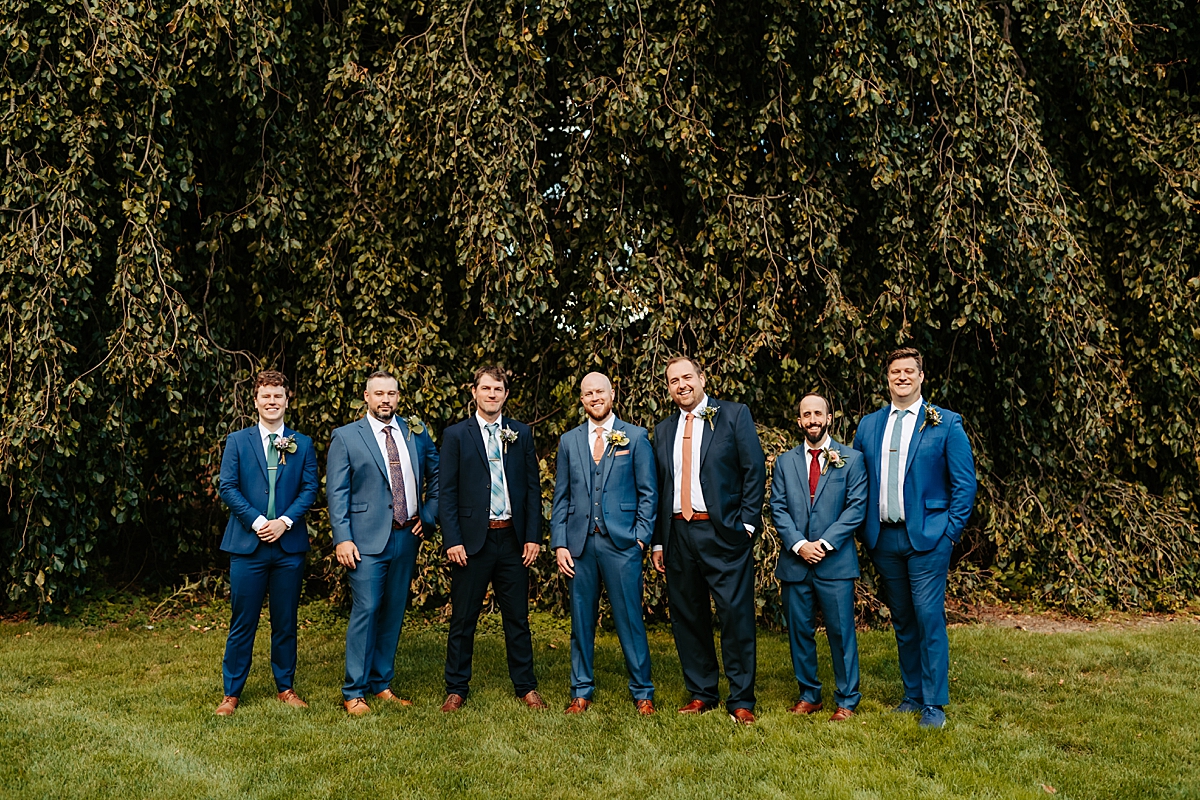 groom with groomsmen wearing navy blue suits