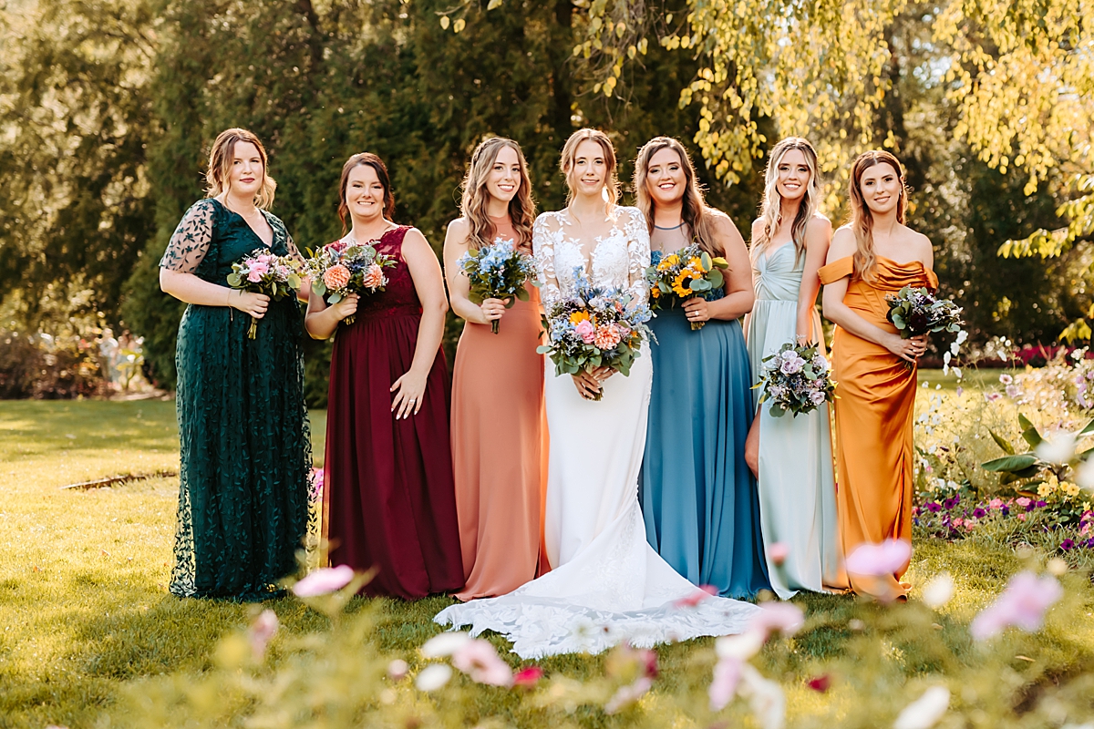 classic bride with bridesmaids in jewel toned dresses