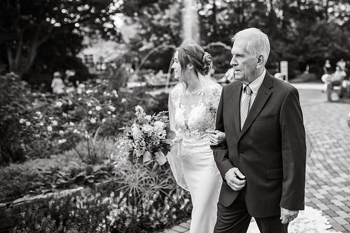 bride and her father walking down the aisle at outdoor fall wedding