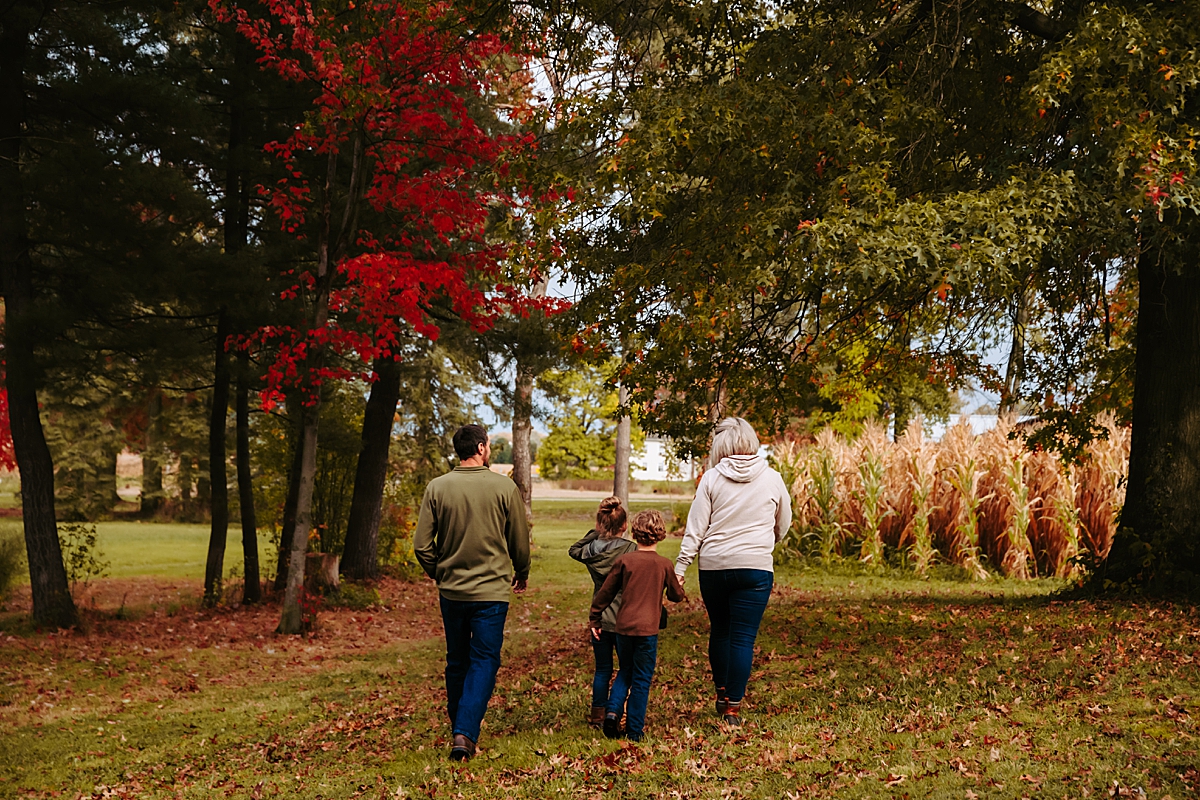 family walking across field holding hands