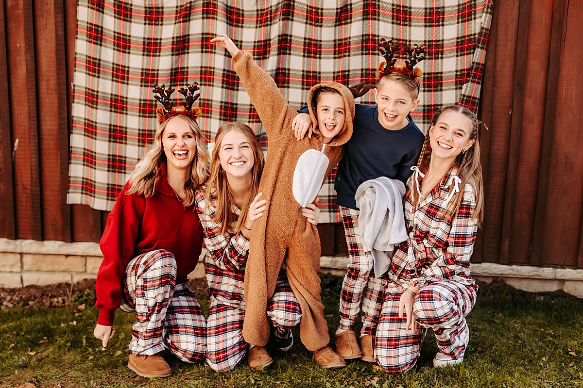 kids in Christmas pajamas laughing and smiling