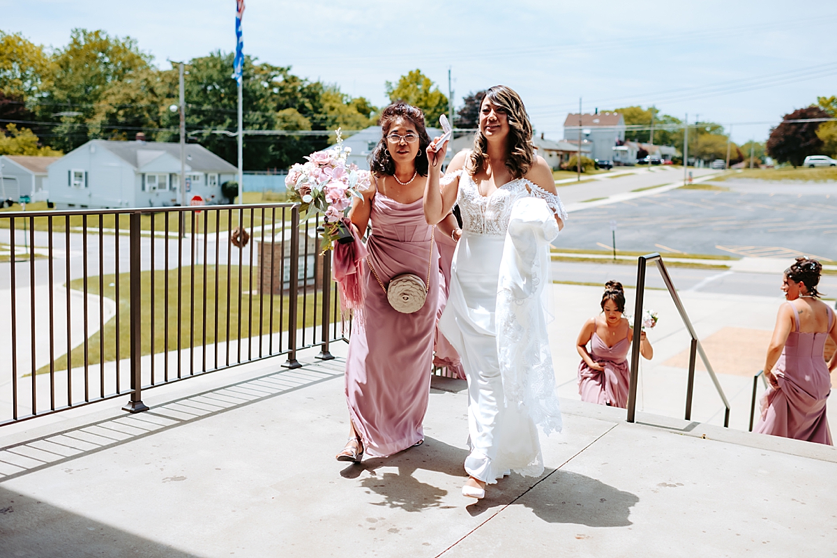 bride and bridesmaids walking into Archangel Michael Greek Orthodox Church