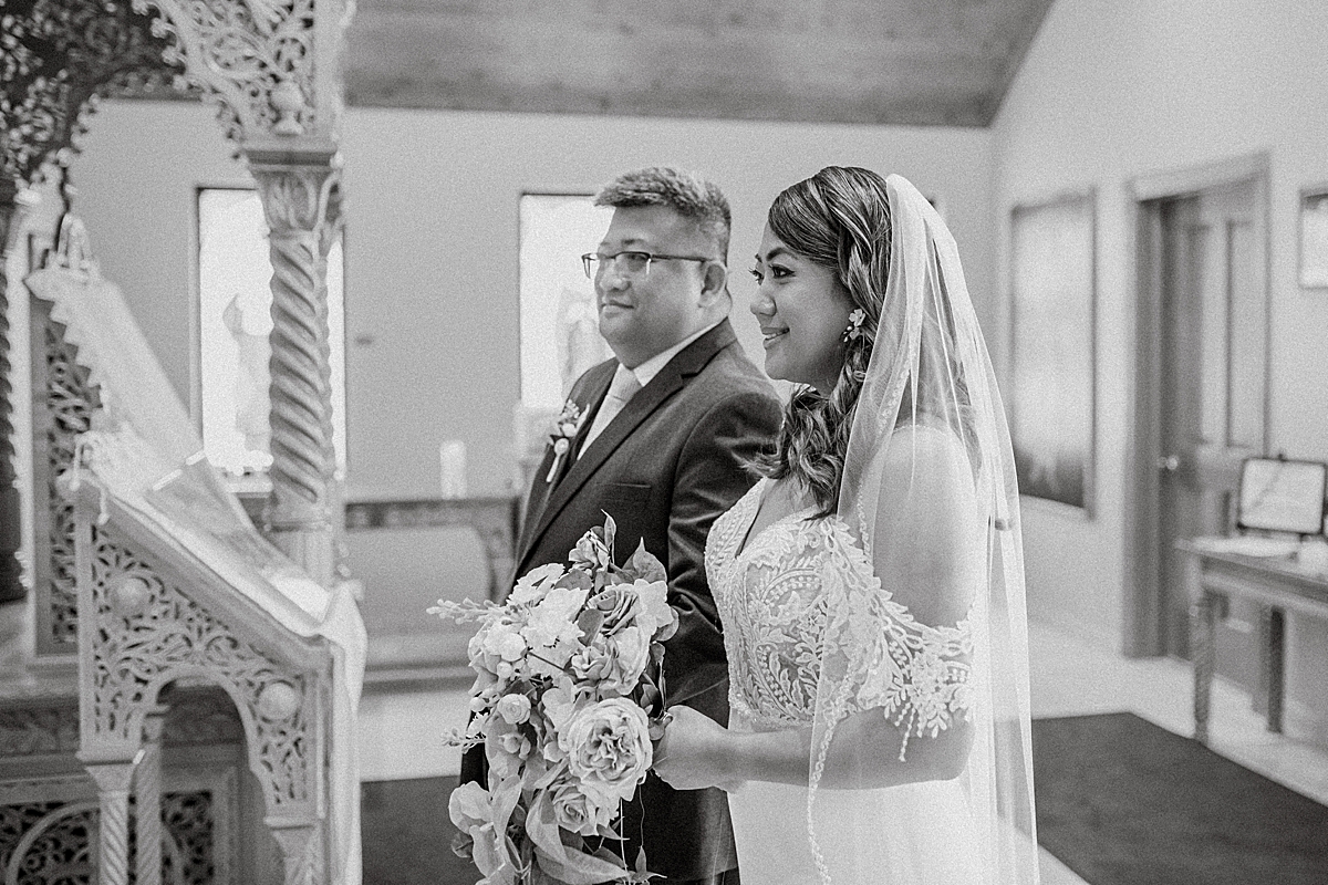 bride and her brother waiting in church lobby to walk down the aisle