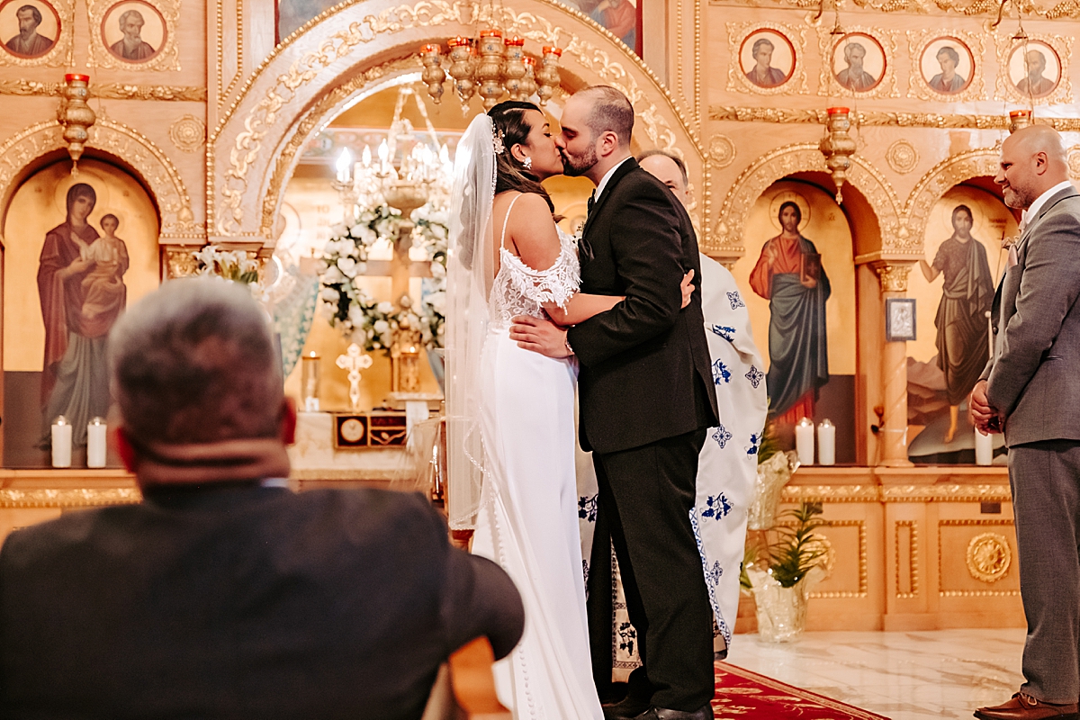 kiss during traditional Greek wedding ceremony in Campbell OH