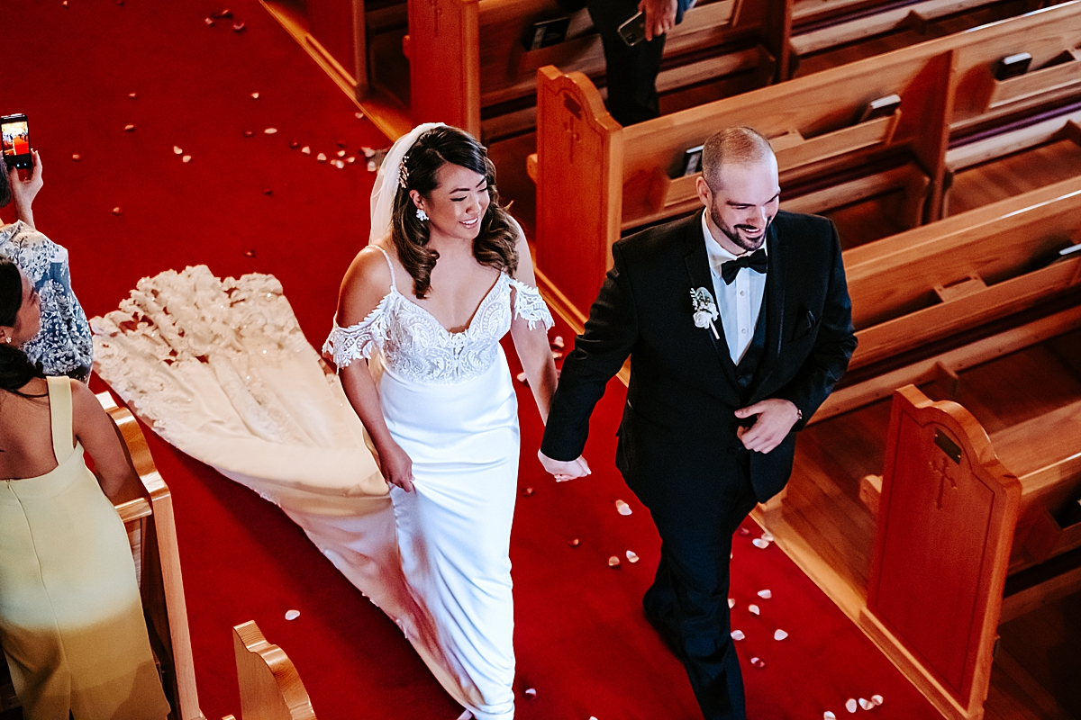 bride and groom walking down the aisle after wedding ceremony