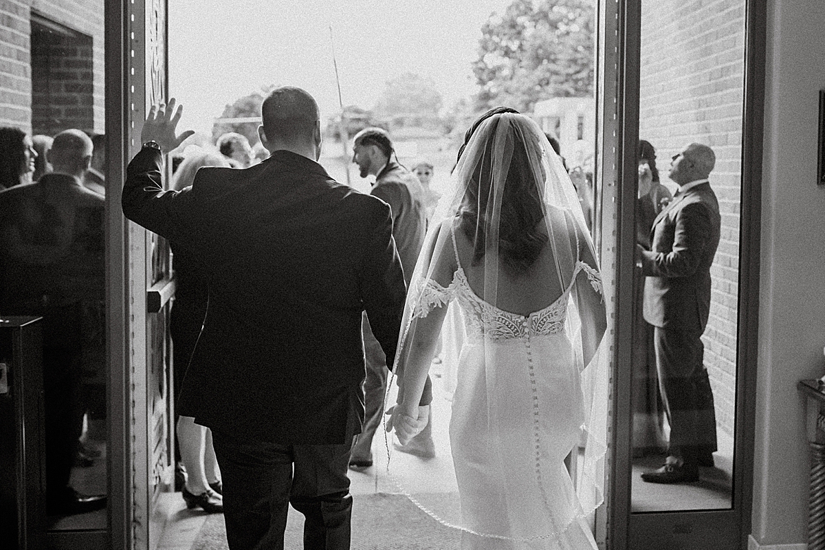 bride and groom walking out church doors for bubble exit