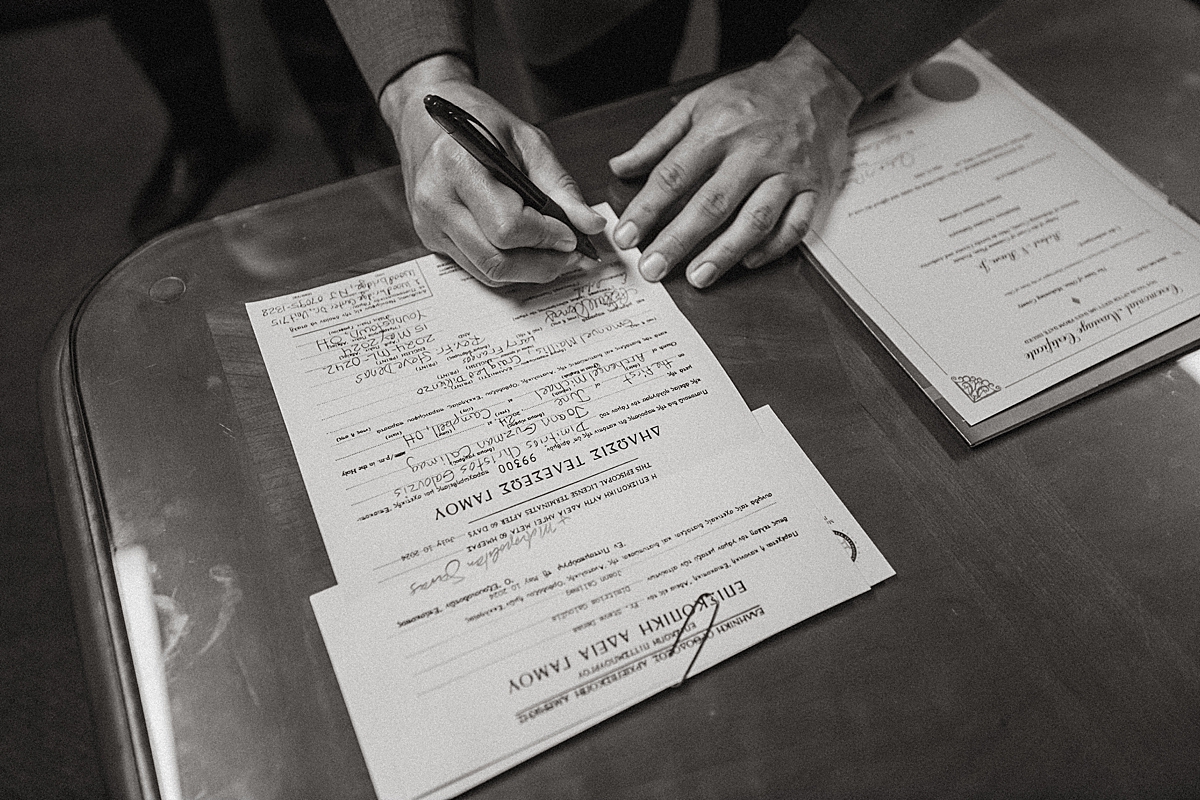 signing Greek marriage license after traditional wedding ceremony