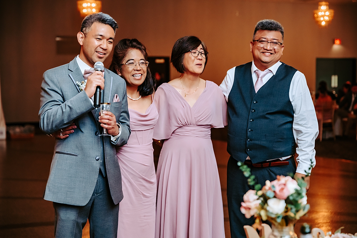 bride's four siblings giving toast during wedding reception