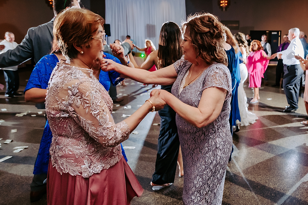 mothers of the bride and groom dancing together at wedding reception