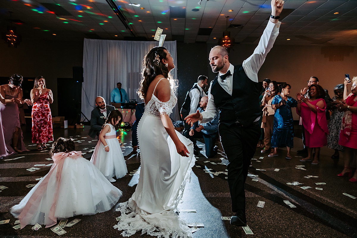 traditional Greek wedding dancing at reception with money on the ground