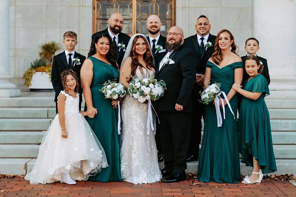 wedding party in emerald green standing on steps at the Butler Institute of American Art