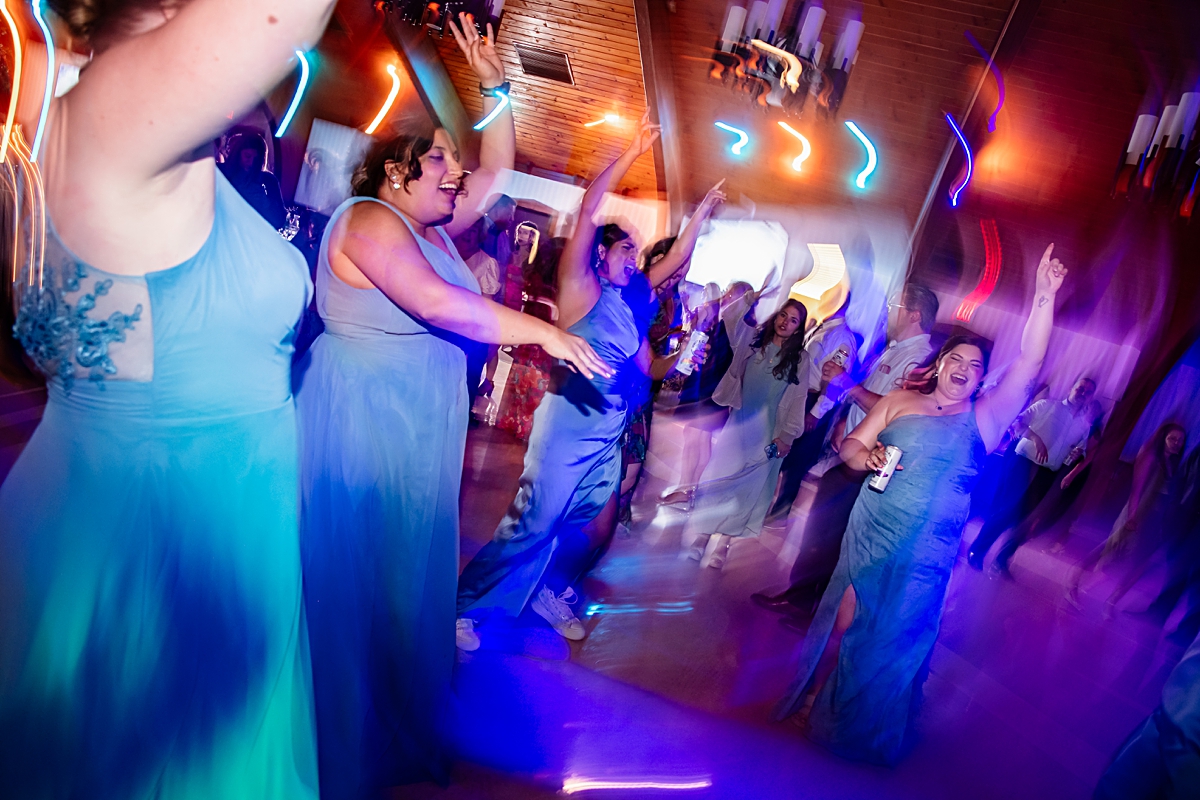 bridesmaids dancing on the dance floor at wedding reception held at Assumption Social Center